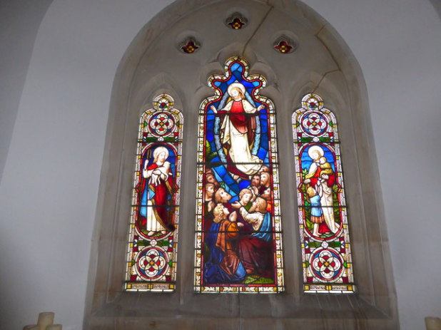 Picture of the East window in the church of St John the Evangelist in Charlton, showing the ascension of Christ